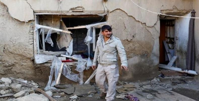 A man inspects a damaged house at the site of an attack in a U.S. military air base in Bagram.  (Photo: Reuters)