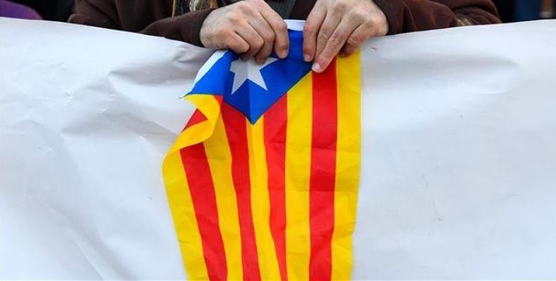 A protester holds a Catalan pro-independence Estelada flag during a protest against the trial of jailed Catalan separatists at the Supreme Court in Madrid on F