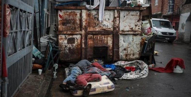 Homeless man sleeps next to a garbage container in Buenos Aires, Argentina.  (Photo: EFE)