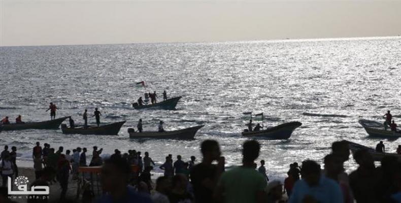 People in the northern part of the besieged Gaza Strip hold a naval rally in protest against the decade-long Israeli siege on the impoverished sliver, on Octobe