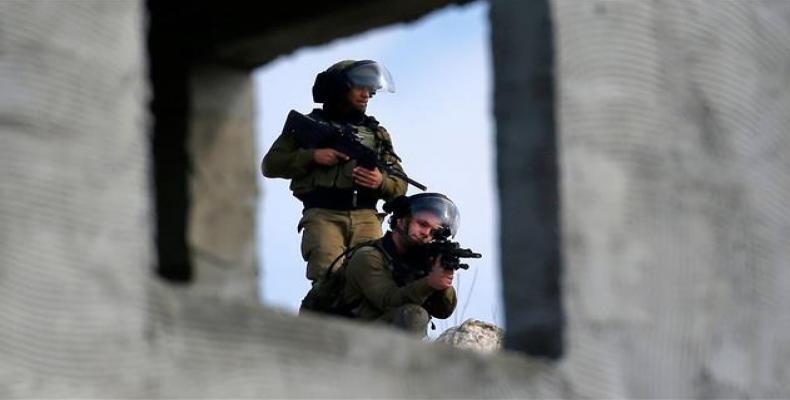 Israeli troopers stand by during clashes with Palestinian demonstrators in the occupied West Bank. (Photo: AFP)